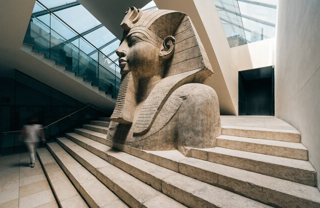 Grand staircase atrium with colossal statue and daylight